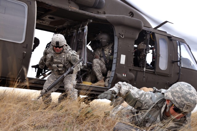 FORT HOOD, Texas-Spc. Alexander Perez (left) and Spc. Cherish Truong,  both radar operators with Battery A, 26th Field Artillery Regiment, (Target Acquisition Battery), 41st Fires Brigade, jumps out of a UH-60 Black Hawk helicopter to pull...