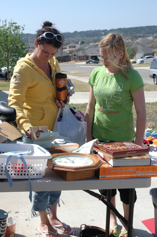 COPPERAS COVE, Texas- Tiffany Draves (left), and her daughter Bailey, look through household items during the "Boobie Brigade" yard sale fundraiser in Copperas Cove, Texas, March 18-19. The yard sale benefits the Susan G. Komen Walk for the Cure Foun...