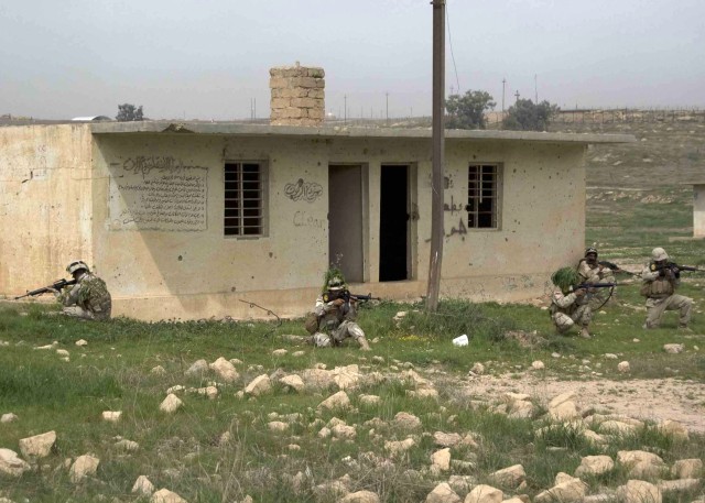 CONTINGENCY OPERATING SITE MAREZ, Iraq - Iraqi soldiers of 3rd Battalion, 11th Brigade, 3rd Iraqi Army Division, set up a cordon outside a training "house" during urban operations training at Ghuzlani Warrior Training Center, March 20, 2011. Soldiers...