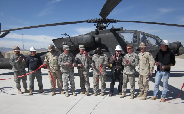 Key personnel from the Forward Arming and Refuelling Point expansion project at Forward Operating Base Shank, Afghanistan, join in the ribbon-cutting ceremony before the first aircraft, an AH-64 Apache helicopter, took on fuel from the new FARP on...