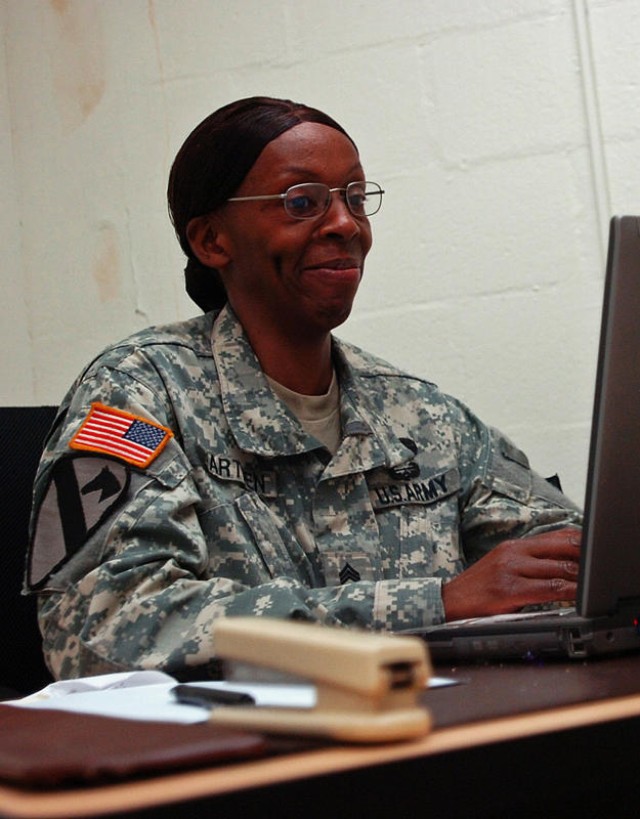 FORT HOOD, Texas - Sgt. 1st Class Elaine Warthen, noncommissioned officer in charge of supply, 589th Brigade Support Battalion, 41st Fires Brigade, checks her email while discussing the path she has taken towards the completion of a doctorate degree ...