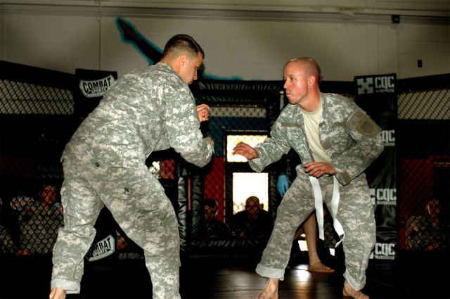 Capt. Ryan Debeltz (right), battery commander for Headquarters and Headquarters Battery, 1st Battalion, 21st Field Artillery Regiment, 41st Fires Brigade, puts up his guard against Spc. Corey (left) Garrell, a motor transport operator for 575th...