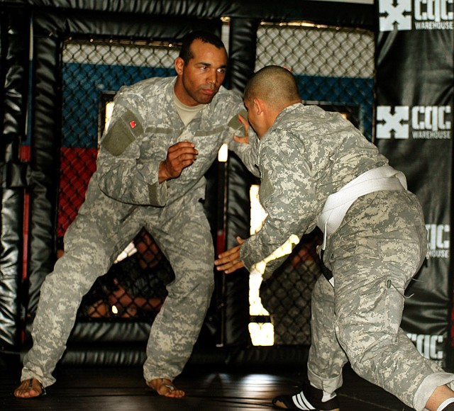 Sgt. Tommy Ferrell (left), a light wheeled vehicle mechanic for Battery A, 1st Battalion, 21st Field Artillery Regiment, 41st Fires Brigade, tries to grab Sgt. Octavius Tryee, a chemical, biological, radiological, nuclear noncommissioned officer...