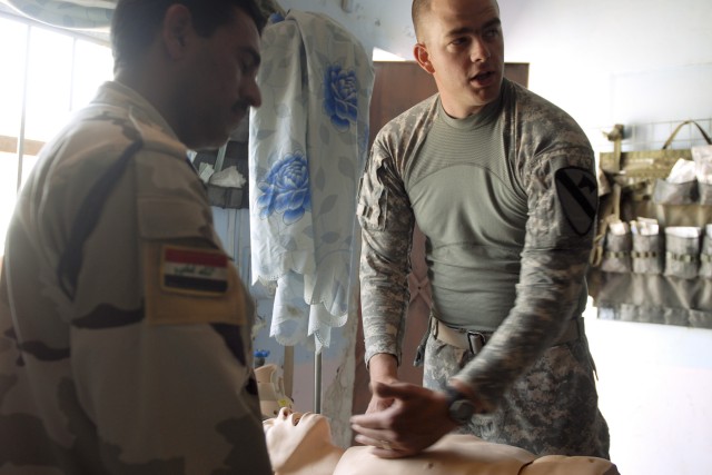 CONTINGENCY OPERATING BASE ADDER, Iraq - Pfc. Ryan Jones (Right), a medic with B Company, 215th Brigade Support Battalion, 3rd Advise and Assist Brigade, 1st Cavalry Division demonstrates the placement of a chest needle decompression, used to relieve...