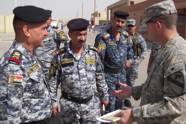 BAGHDAD-Lt. Col. Cameron Cantlon (right), the commander of 6th Squadron, 9th Cavalry Regiment, 2nd Advise and Assist Brigade, 1st Infantry Division, United States Division - Center, discusses with Staff Maj. Gen. Baha'a, the commander of the 4th...