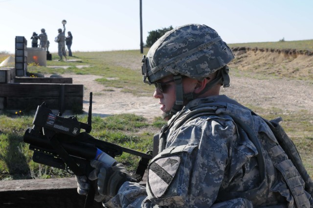 FORT HOOD, Texas - Cpl. Taylor Knox, a Buckfield, Maine native with 1st Battalion, 8th Cavalry Regiment, 2nd Brigade Combat Team, 1st Cavalry Division, loads a paint round into a M320 grenade launcher during training on Fort Hood, Texas, April 1....