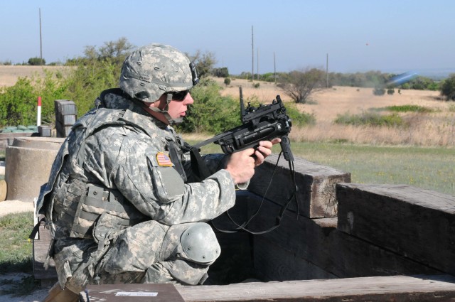 FORT HOOD, Texas - Pvt. Samuel Carlson, from Loveland, Colo., an armor crewman with 1st Battalion, 8th Cavalry Regiment, 2nd Brigade Combat Team, 1st Cavalry Division, fires a paint round out of an M320 grenade launcher during training on Fort...
