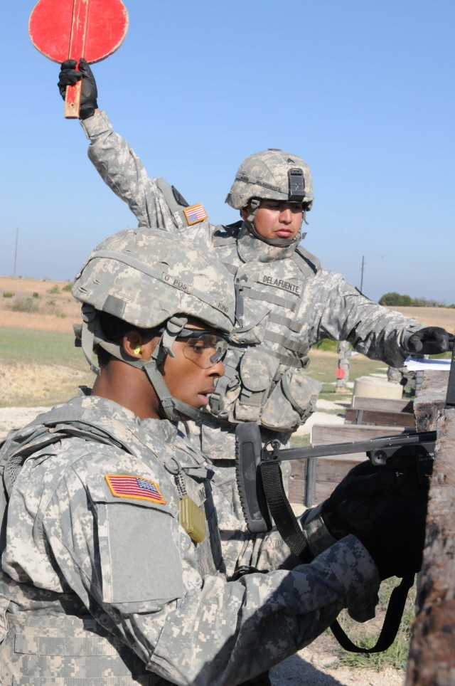 FORT HOOD, Texas - Sgt. Hector Delafuente, a Houston native with 2nd Special Troops Battalion, 2nd Brigade Combat Team, 1st Cavalry Division, holds up a paddle before Spc. Reginald King, also a Houston native serving with 1st Battalion, 8th...