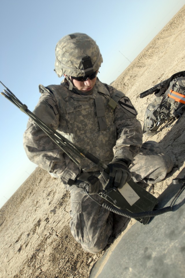 CONTINGENCY OPERATING BASE ADDER, Iraq - Pfc. Larry Reed, with 3rd Brigade Special Troops Battalion, 3rd Advise and Assist Brigade, 1st Cavalry Division, attaches an antenna to a radio, March 31, during a Soldier/Non-commissioned Officer of the...