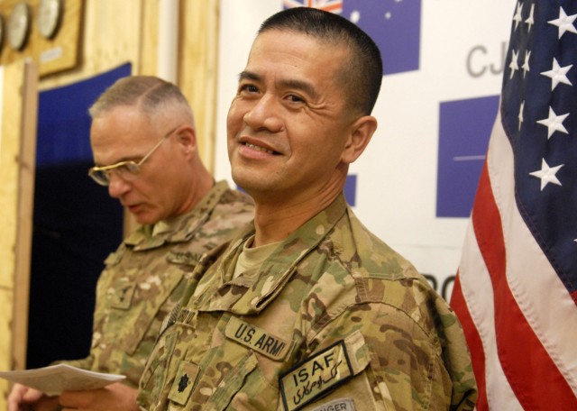 Lt. Col Oswald C. Arroyo, officer in charge of the Combined Joint Resource Management Shop for Regional Command-South, with Intelligence and Sustainment Company, Headquarters and Headquarters Battalion, 10th Mountain Division (LI), prepares to reaffi...