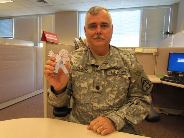 Lt. Col Clark Poses With A Copy Of the Flat Stanley