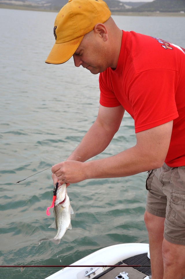 HARKER HEIGHTS, Texas-Lt. Col. James Davel, a Shawano, Wis. native, battalion commander for 1st Battalion, 21st Field Artillery Regiment, 41st Fires Brigade, catches a bass during the Brig. Gen. Charles B. Allen Memorial Bass Tournament at...
