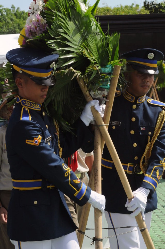 Filipino service members carry wreath