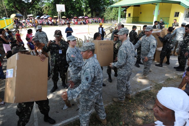 Philippine and US service members unload donated items