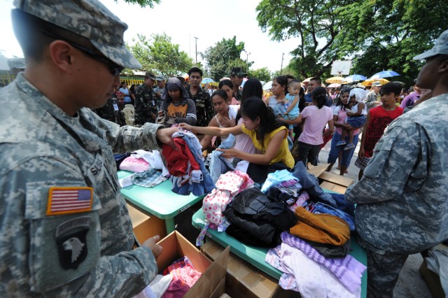 US Soldiers pass out clothing donations