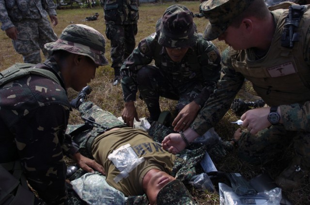 Armed Forces Philippines service members treat a chest wound