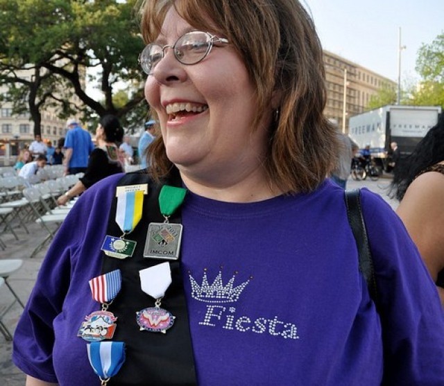 Maggie Brewster, director of Installation Management community relations, displays her sash with the IMCOM Fiesta 2011 medal