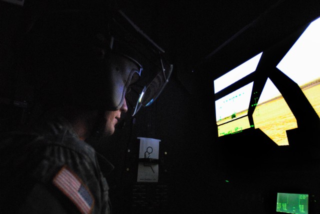 FORT RUCKER, Ala. - 1st Lt. Jacob Lawson, of Naples Fla., a platoon leader in Task Force Attack, 1st Air Cavalry Brigade, 1st Cavalry Division, displays what he sees in his helmet on a monitor while in a flight simulatorat the Seneff Aviation...