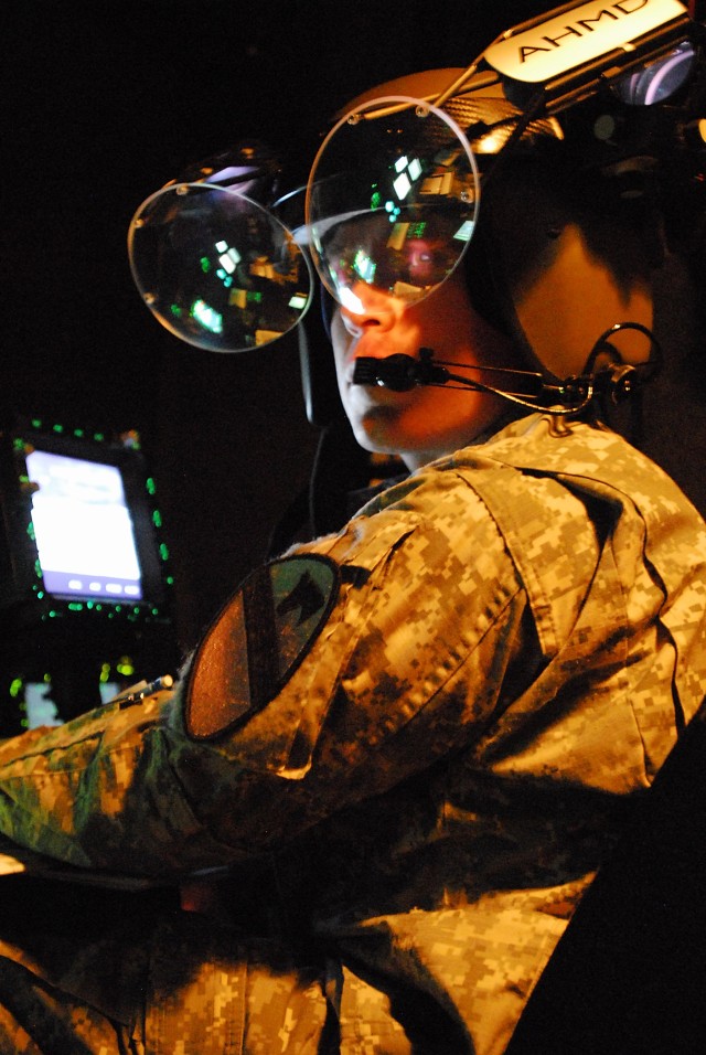 FORT RUCKER, Ala. - Chief Warrant Officer 2 Josh Robertson, from Deming N.M., a tactical operations officer with in Task Force Attack, 1st Air Cavalry Brigade, 1st Cavalry Division, operates the Re-configurable Training Device, a flight simulator,...