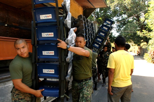 Troops deliver chairs, desks to multiple school sites 