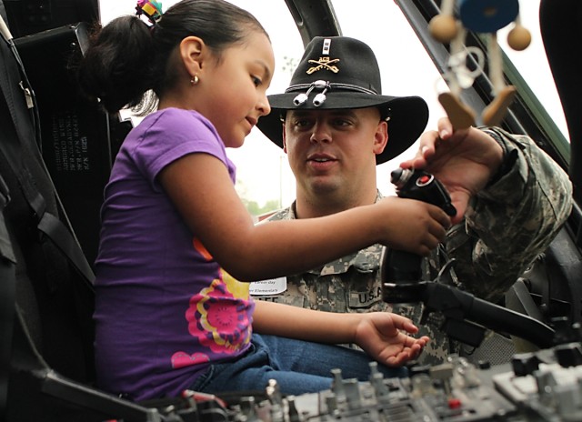 FORT HOOD, Texas-Chief Warrant Officer 2 Bryan Lee, a pilot with Company C, Task Force Spearhead, 1st Air Cavalry Brigade, 1st Cavalry Division, from Plugerville, Texas, explains the functions of a cyclic stick on a UH-60A Black Hawk helicopter to...