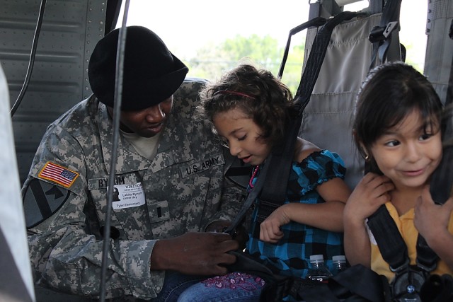 FORT HOOD, Texas-1st Lt. Lakito Bynum, a maintenance platoon leader for Company E, Task Force Spearhead, 1st Air Cavalry Brigade, 1st Cavalry Division, originally from Charleston, Miss., buckles in a student  inside of a UH-60A Black Hawk...