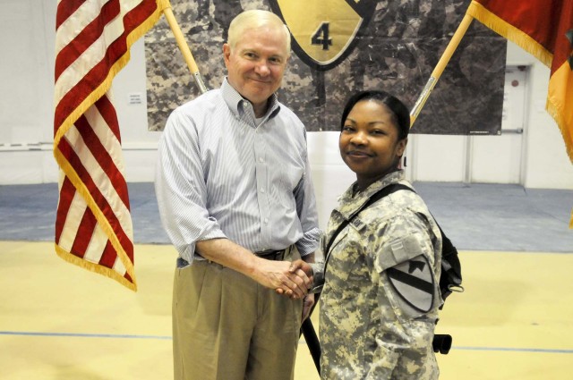 Secretary of Defense Robert M. Gates presents Spc. Jamie Leblanc, 4th Advise and Assist Brigade, 1st Cavalry Division, with a coin of excellence during his visit to Contingency Operating Site Marez, April 8, 2011. Gates held a question-and-answer ses...