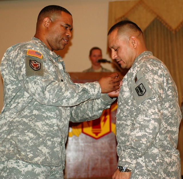 FORT HOOD, Texas-Sgt. 1st Class Armando Rivera (right), a Brownsville, Texas native, receives the Military Outstanding Volunteer Service medal during the brigade's award ceremony April 13. Rivera received his award for volunteering his time at...