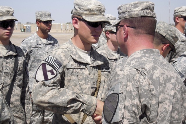 BAGHDAD-Pfc. Zachary Polsin (left), of C Troop, 6th Squadron, 9th Cavalry Regiment, 2nd Advise and Assist Brigade, 1st Infantry Division, United States Division - Center, from Spokane, Wash., is congratulated by Sgt. 1st Class Matthew Sanders,...