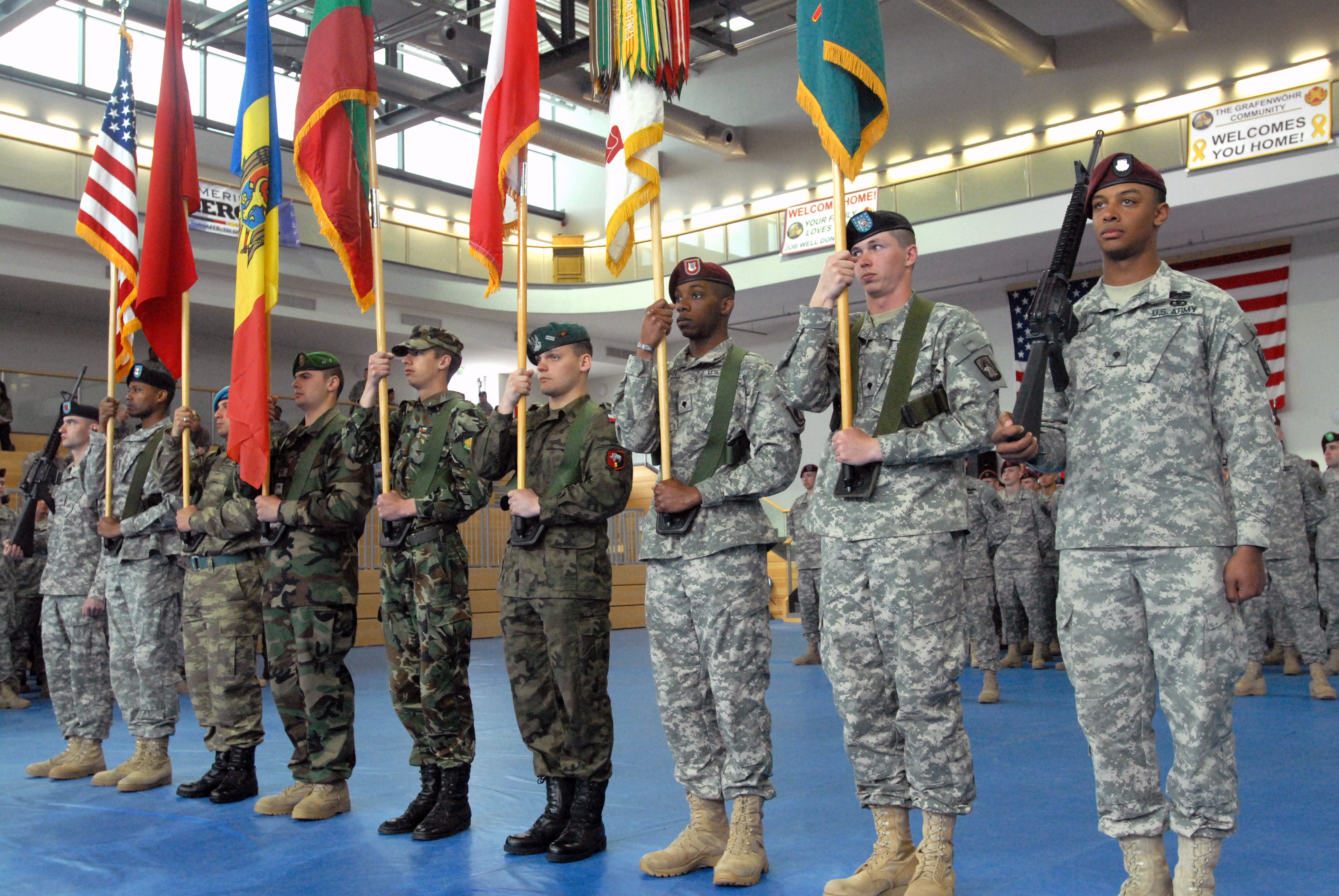 A U.S. Army Soldier assigned to the NCO Academy at Camp Normandy, waits for  his baseball to be signed by Clark, the Chicago Cubs mascot, at  Grafenwoehr, Germany, Dec. 11, 2018. The