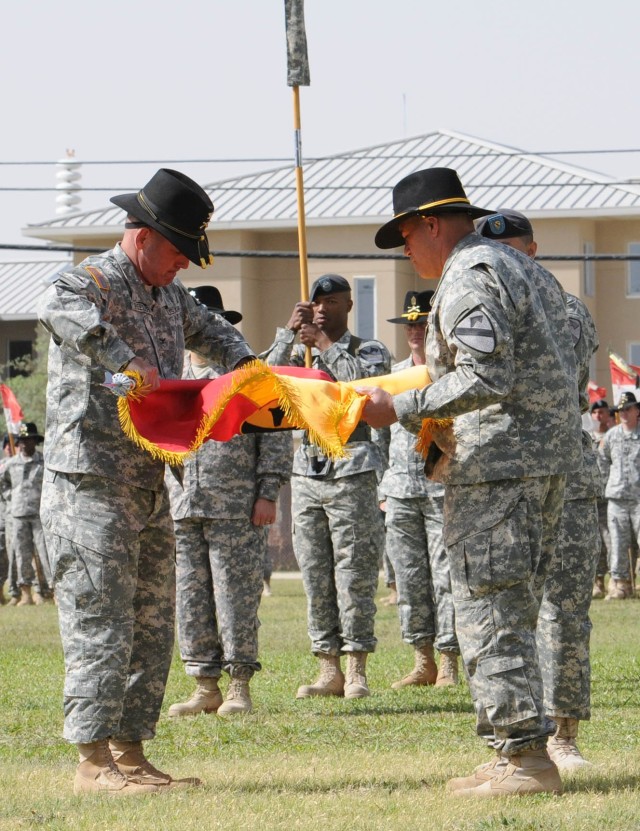 FORT HOOD, Texas - Col. John Peeler (left), commander of the 2nd Brigade Combat Team, 1st Cavalry Division, and Sgt. Maj. Emmett Maunakea, case their brigade colors during the 1st Cav. Div. Color Casing Ceremony on Fort Hood, Texas, April 15. The...