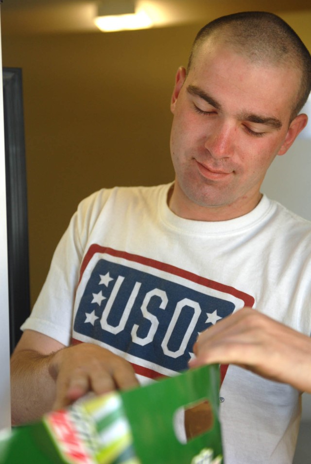 Pfc. Phillip Plack, from Kansas City, Mo., and a scout assigned to Troop B, 1st Squadron, 7th Cavalry Regiment, 1st Brigade Combat Team, 1st Cavalry Division, reloads the refrigerator at the United Service Organization center, here, April 15,...