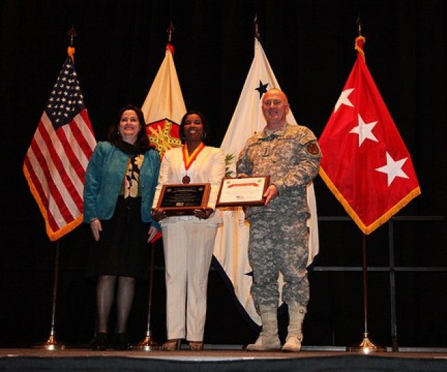 Stalwart Award-winner Shaunya Murrill stands between Ms. Hammack and Lt. Gen Lynch with her shadow box