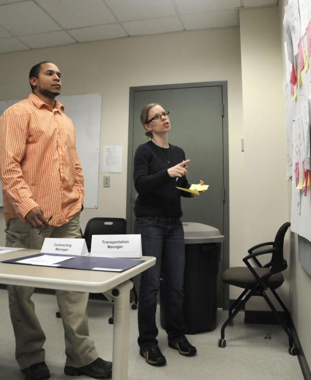 Quatrell Walker, logistic management specialist, and Laura Swatsworth, Mission Support Element, Medical Operations / Patient Administrative Division, brainstorm issue resolutions during a budget documtation simulation. The two-week simulation...