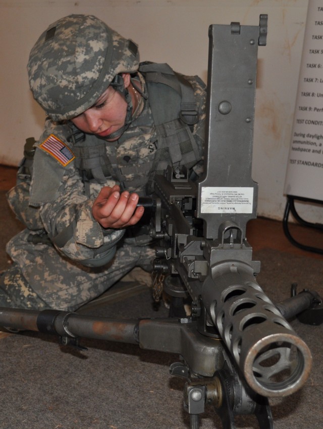 SCHOFIELD BARRACKS, Hawaii -- Spc. Jessica Storch, a medic with the 1984th U.S. Army Hospital, disassembles an M2-50 caliber machine gun during the weapons demonstration portion of this year's 9th Mission Support Command Best Warrior Competition, her...
