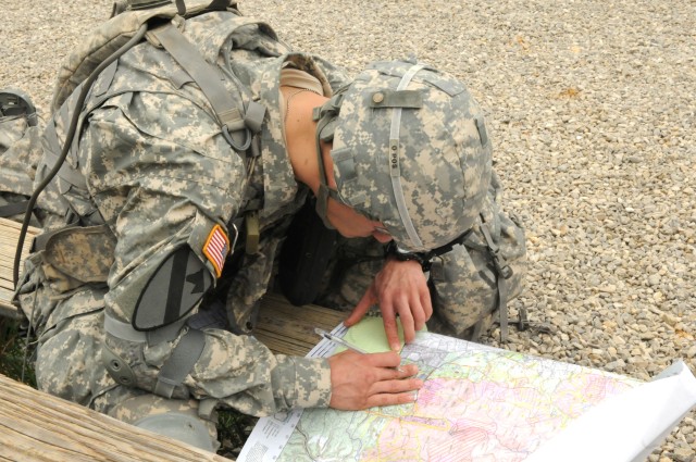 Sgt. Bryan Cyr, a mechanic with the 149th Seaport Operations Company, 10th Transportation Battalion, 7th Sustainment Brigade, plots points during the land navigation event of the 3d Sustainment Command (Expeditionary)'s NCO and Soldier of the Year...
