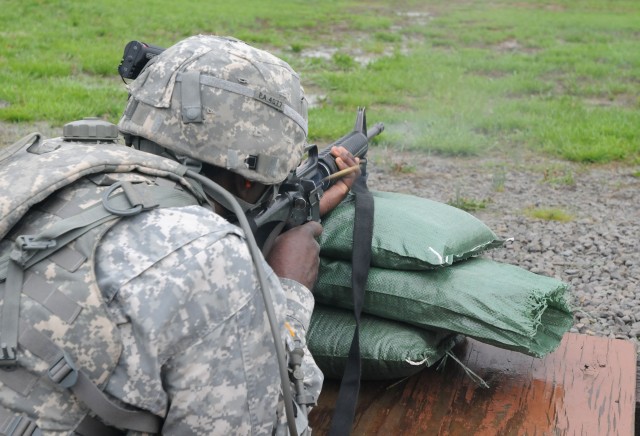 Sgt. Darell Parker, a fueler with the 530th Combat Sustainment Support Battalion, fires the M16 rifle during the weapon qualification event of the 3d Sustainment Command (Expeditionary)'s NCO and Soldier of the Year competition April 20. The...