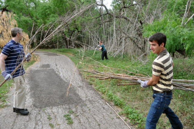 USAEC and IMCOM employees clear out dead brush at John James Park on Earth Day.
