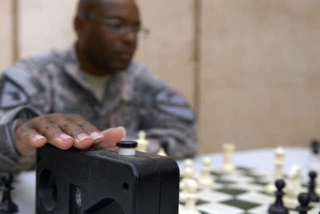 CONTINGENCY OPERATING BASE ADDER, Iraq - 1st Lt. Shelby Johnson, the executive officer of B Company, 3rd Brigade Special Troops Battalion, 3rd Advise and Assist Brigade, 1st Cavalry Division stops his clock during a chess game with a friend on...