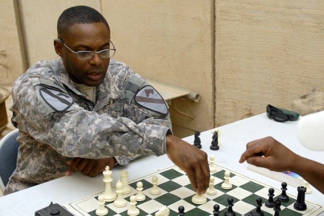 CONTINGENCY OPERATING BASE ADDER, Iraq - 1st Lt. Shelby Johnson, the executive officer of B Company, 3rd Brigade Special Troops Battalion, 3rd Advise and Assist Brigade, 1st Cavalry Division, plays chess with a friend at Contingency Operating Base...