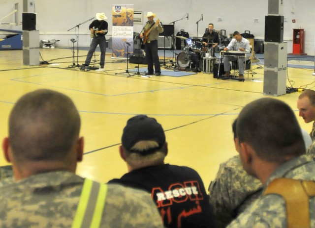 CONTINGENCY OPERATING SITE MAREZ, Iraq - Soldiers assigned to 4th Advise and Assist Brigade, 1st Cavalry Division, and civilian contractors watch the Air Forces Central band, "Wild Blue Country" perform at the Contingency Operating Site Marez main...
