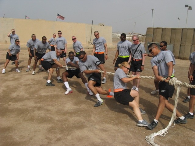 Contingency Operating Base Basrah, Iraq - Soldiers from 3rd Platoon, Alpha Distribution Company, 215th Brigade Support Battalion, 3rd Brigade Combat Team, 1st Cavalry Division, struggle to win the tug-of-war competition.  From left to right on the...