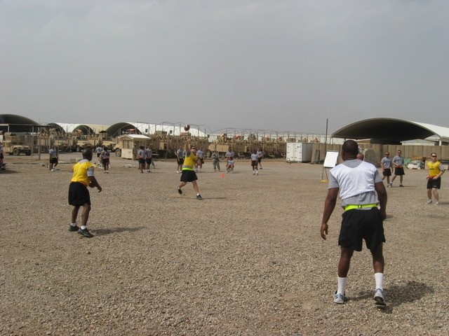 Contingency Operating Base Basrah, Iraq - Sgt. Alejandro Cosme throws a touchdown pass in the Ultimate Football competition, part of the Alpha Distribution Company, 215th Brigade Support Battalion, 3rd Brigade Combat Team, 1st Cavalry Division,...