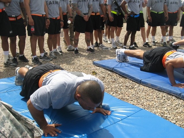 Contingency Operating Base Basrah, Iraq - 1st Sgt. Jesus Seary competes in the push-up event for the Alpha Distribution Company, 215th Brigade Support Battalion, 3rd Brigade Combat Team, 1st Cavalry Division, Organizational Day.  1st Sgt. Seary...
