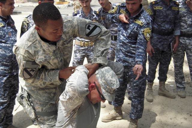 BAGHDAD—Staff Sgt. Cedric Wilson of Bandit Troop, 6th "Saber" Squadron, 9th Cavalry Regiment, 2nd Advise and Assist Brigade, 1st Infantry Division, United States Division – Center, and a native of Leesville, La., with Staff Sgt. Jason Beaudre,...