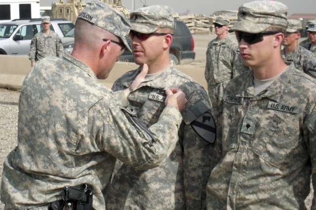 CAMP LIBERTY, Iraq - Lt. Col. Cameron Cantlon, a native of Ettrick, Wis., and commander of 6th "Saber" Squadron, 9th Cavalry Regiment, 2nd Advise and Assist Brigade, 1st Infantry Division, United States Division - Center pins the Combat Action...