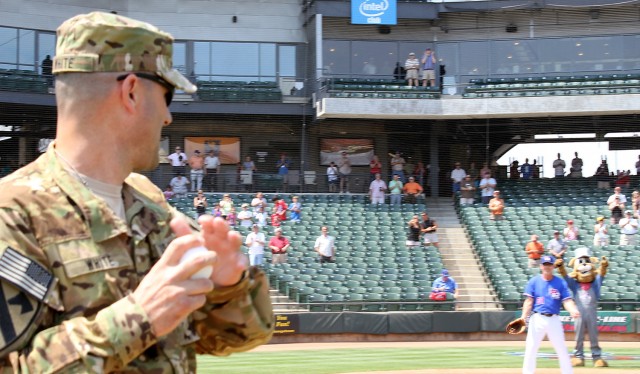 ROUND ROCK, Texas-Lt. Col. Jeff White, commander, Task Force Guns, 1st Air Cavalry Brigade, 1st Cavalry Division, originally from Boston, throws out the ceremonial first pitch at a Round Rock Express minor league baseball game May 9. The team is an a...