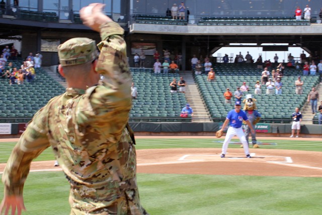 ROUND ROCK, Texas-Lt. Col. Jeff White, commander, Task Force Guns, 1st Air Cavalry Brigade, 1st Cavalry Division, originally from Boston, throws out the ceremonial first pitch at a Round Rock Express minor league baseball game May 9. The team is an a...