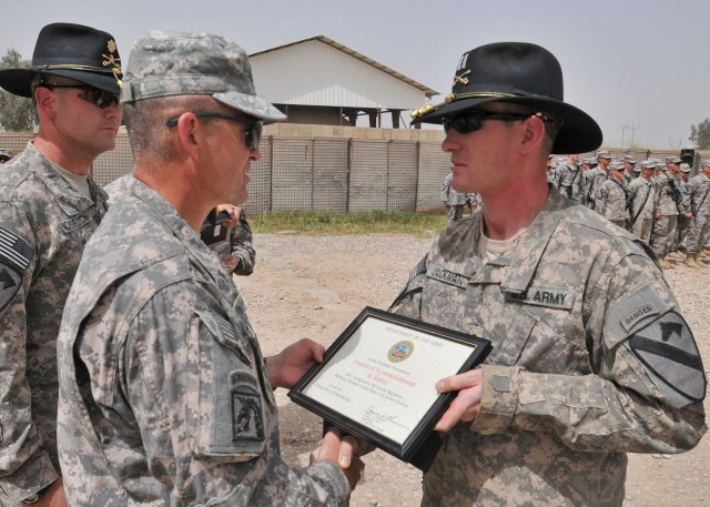 CONTINGENCY OPERATING SITE MAREZ, Iraq - Maj. Gen. Daniel Allyn, commanding general of 1st Cavalry Division, awards Capt. Ben Jackman, outgoing commander of Headquarters and Headquarters Troop, 1st Squadron, 9th Cavalry Regiment, 4th Advise and Assis...