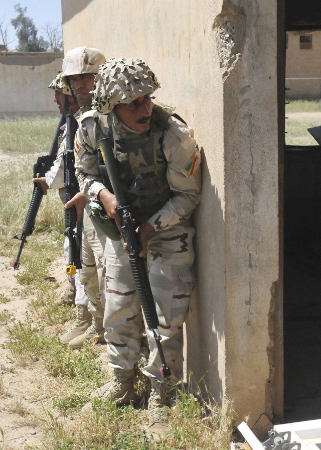 Iraqi Soldier prepares to enter building